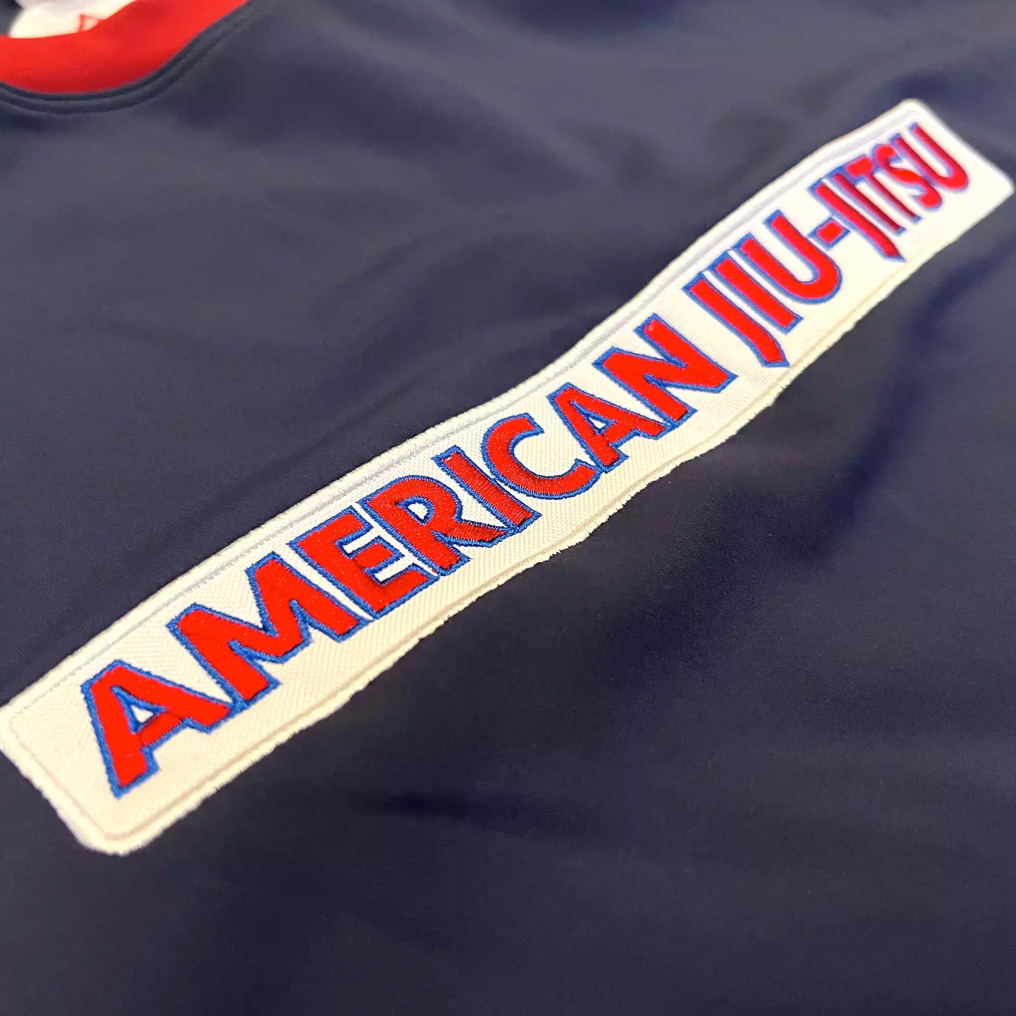 GRW American Jiu Jitsu BJJ Rash Guard patches red white blue AJJ patch closeup